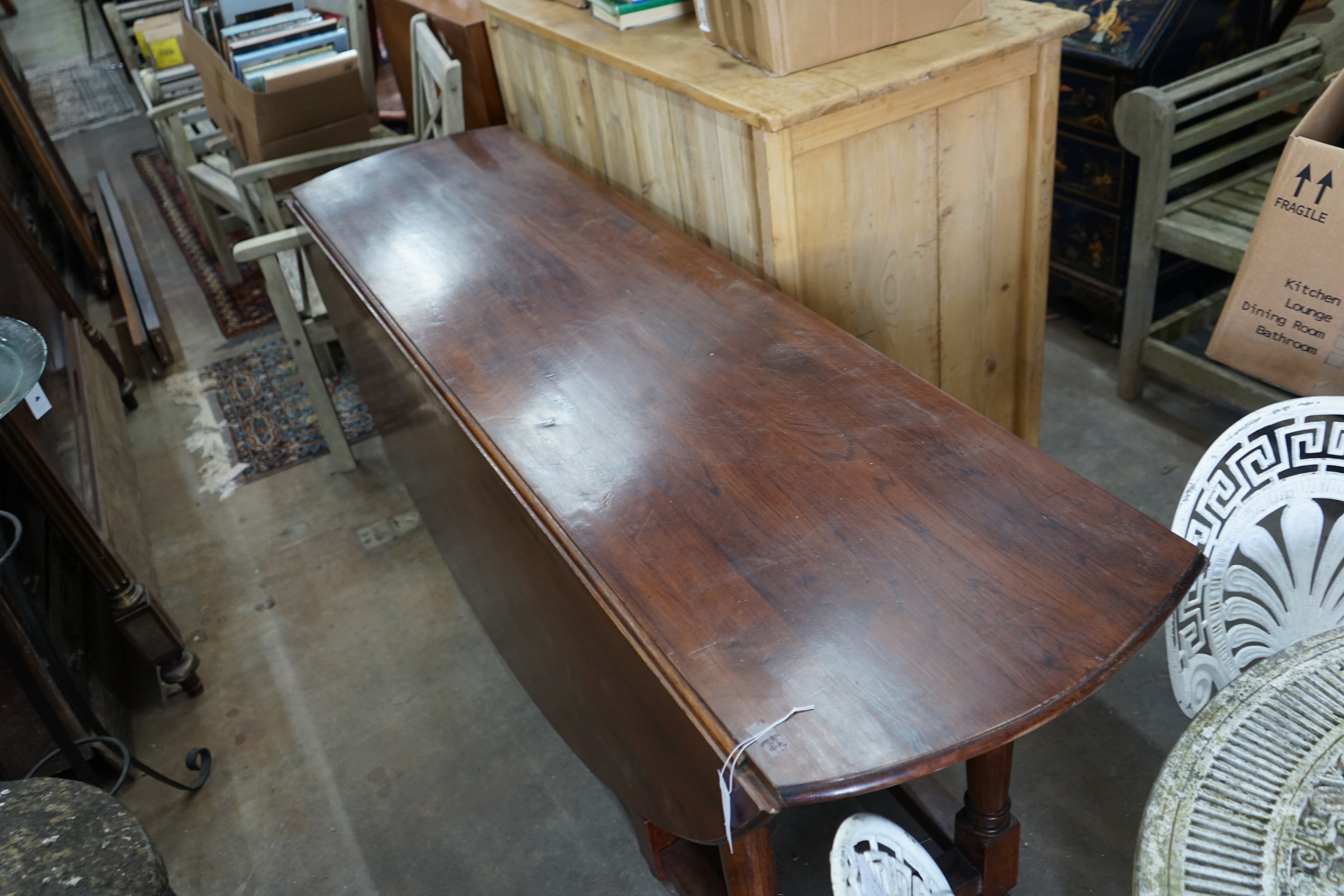 An 18th century style oak gateleg wake dining table, length 190cm extended 150cm height 79cm